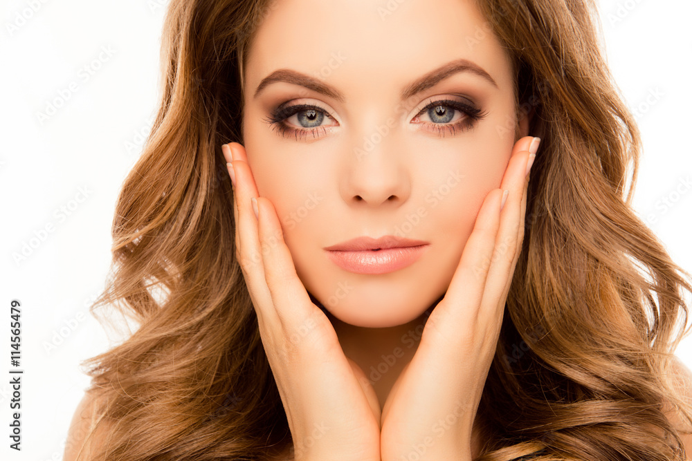 Portrait of serious attractive girl touching her face