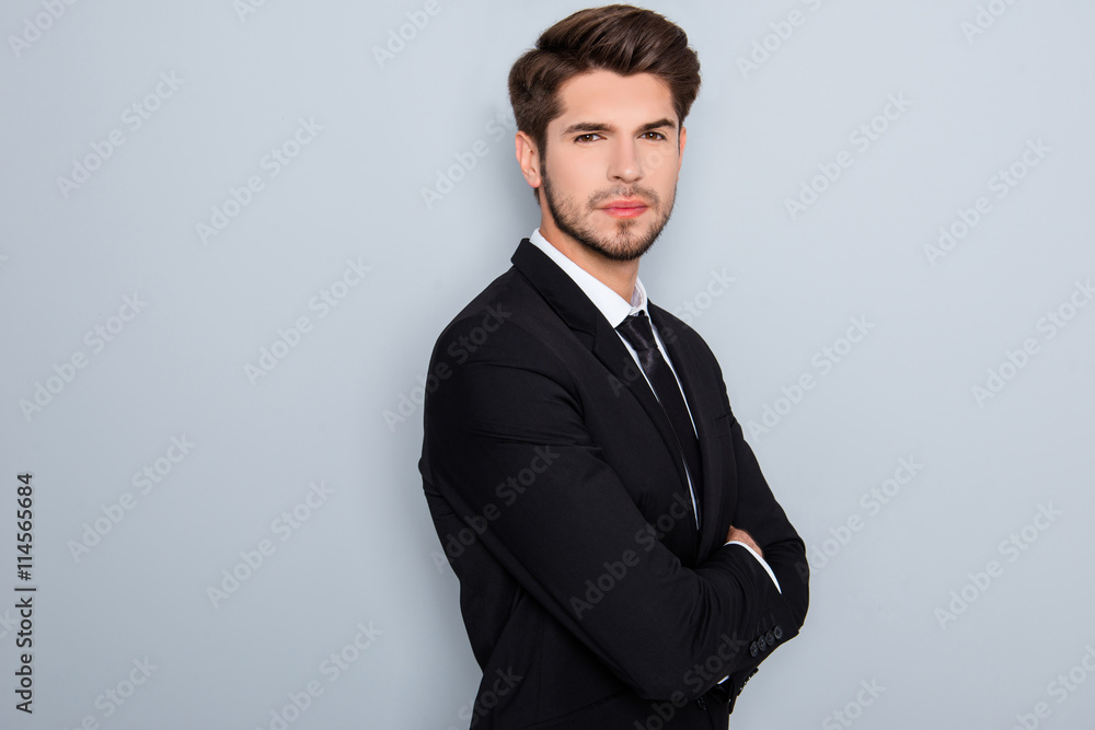 Confident serious successful businessman in suit with crossed h Confident serious successful businessman in suit with crossed h