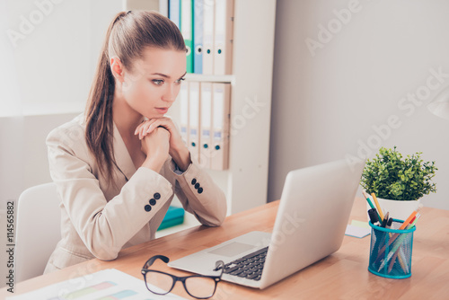Portrait of ponder woman with laptop thinking about problem on w