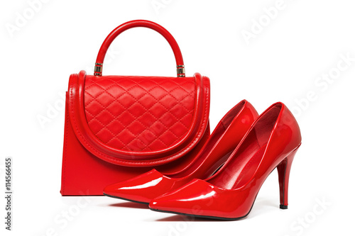 Fotografija Red female leather shoes and red leather bag on white background