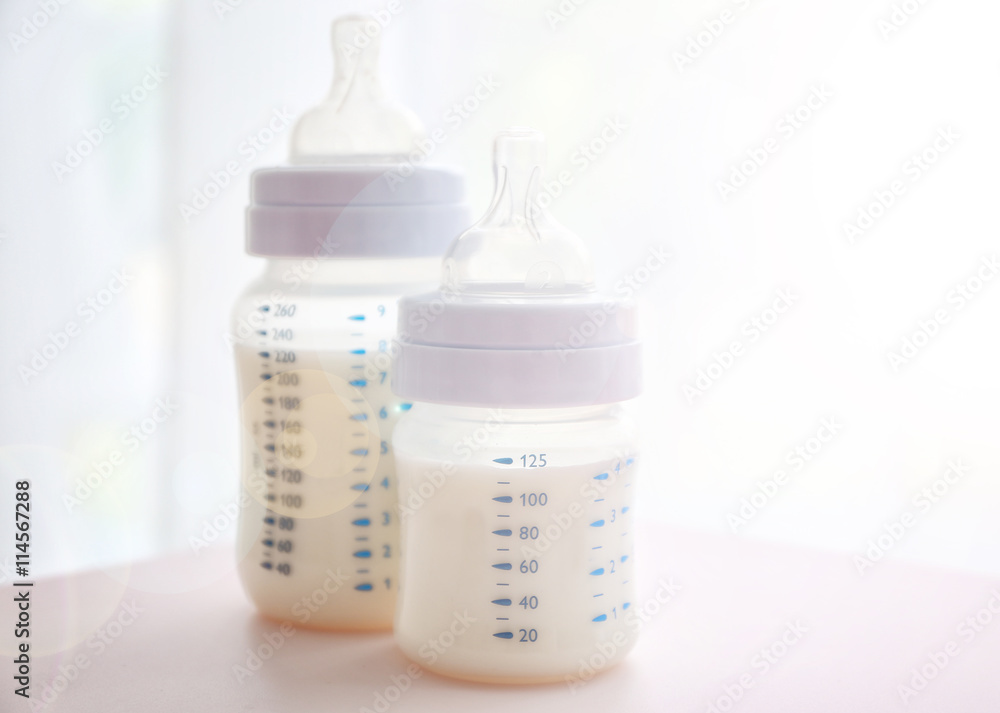 Baby milk bottles and pacifier on white background Baby milk bottles and pacifier on white background