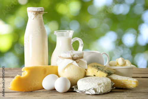 Set of fresh dairy products on wooden table on natural background