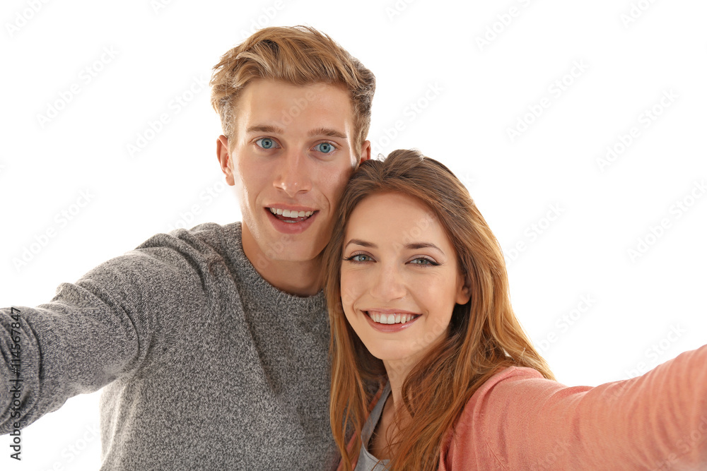 Young cheerful friends taking selfie isolated on white Young cheerful friends taking selfie isolated on white