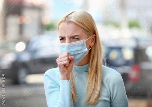 Woman in protective mask outdoors