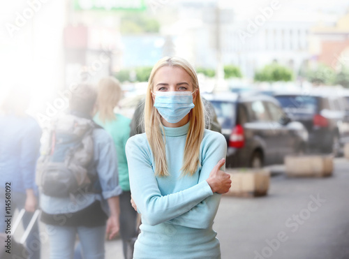 Woman in protective mask outdoors