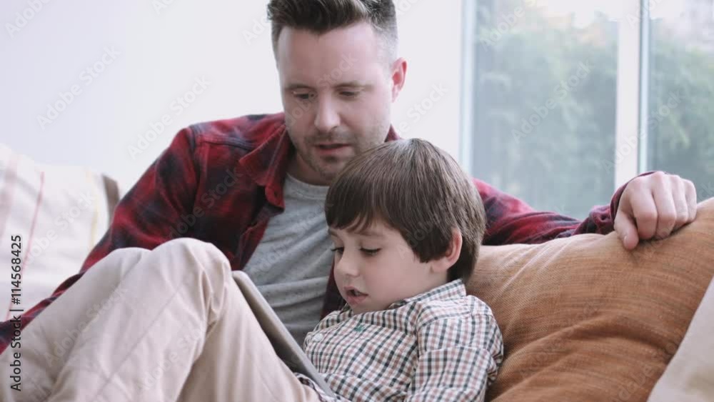 Father and son watching digital tablet Father and son watching digital tablet