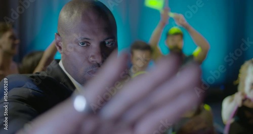 Bouncer gesturing in nightclub