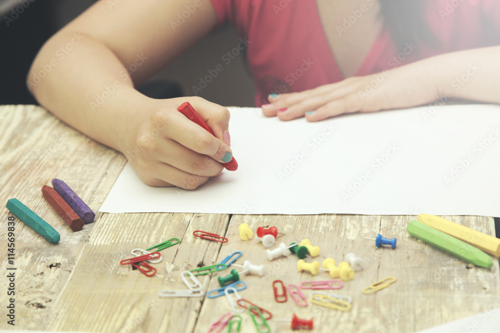 Little girl hand pencils