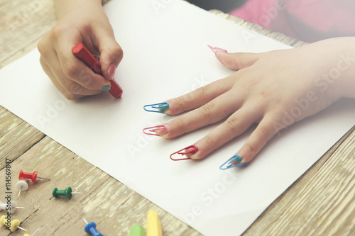 Little girl hand pencils