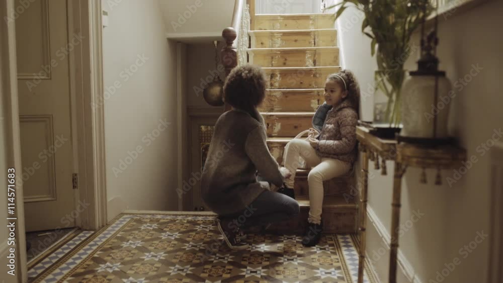 Mother preparing daughter for school at home