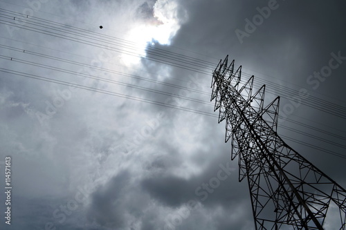Silhouette of electricity post in cloudy sky,low angle shot.high voltage electric pole,high voltage power supply,high voltage power line.
