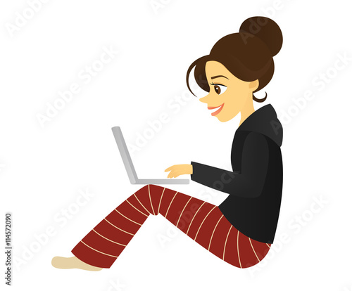 Woman in pajamas sitting and using a laptop computer