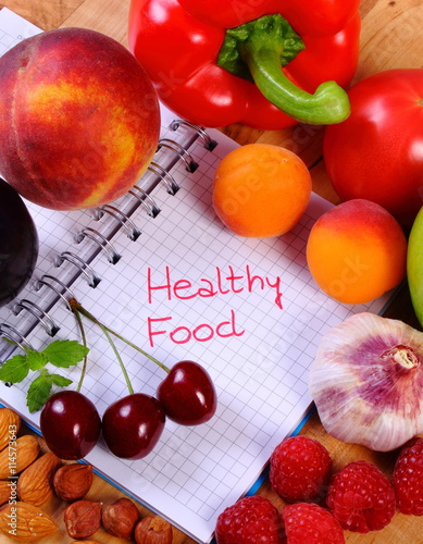 Fruits and vegetables with notebook, slimming and healthy food