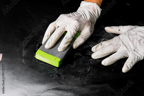 worker polishing with sand paper