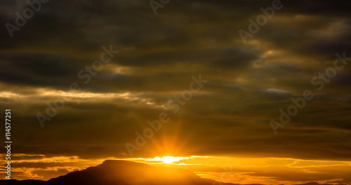 Sunrise in cloudscape over mountains © jaboo_foto