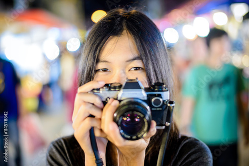 portrait asian girl hold vintage photo camera on vintage background