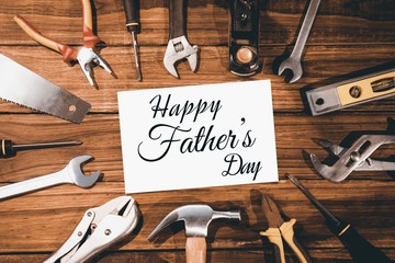 Happy fathers day message surrounded by tools