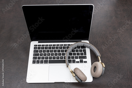 Laptop on a desk with headphones