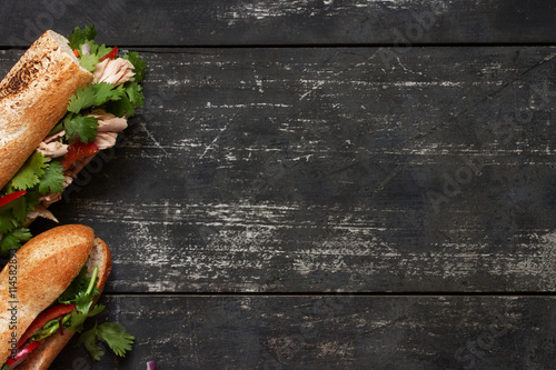 Two tuna sandwich on dark wood background photo