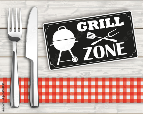 Grillzone - Messer und Gabel an einem Holztisch