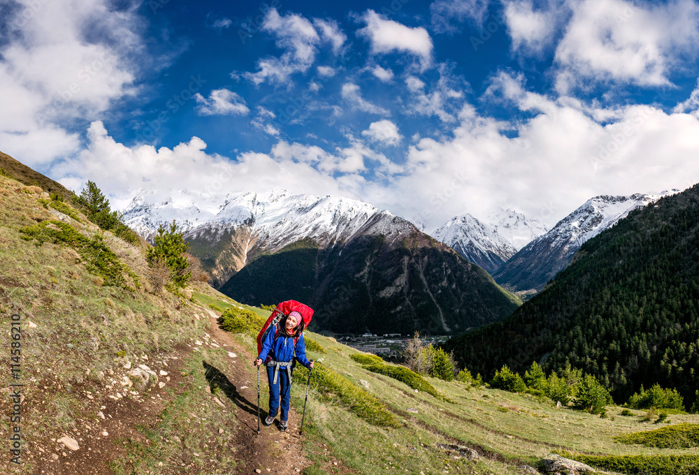 Fototapeta premium Woman mountain Hiker with backpack enjoy view in Caucasus mountains, Elbrus region, Russia.