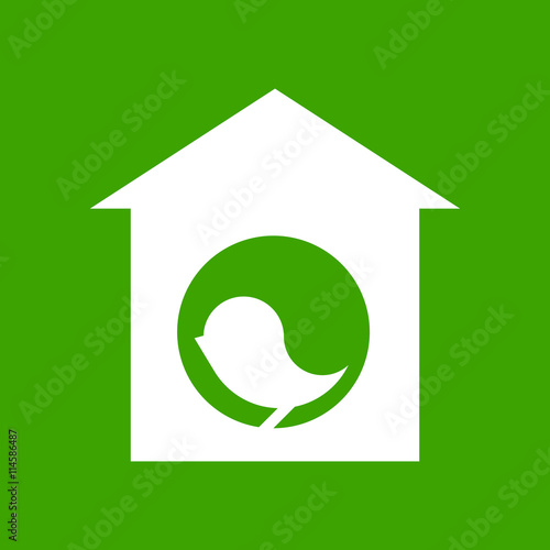 White silhouette of bird in birdhouse on green background