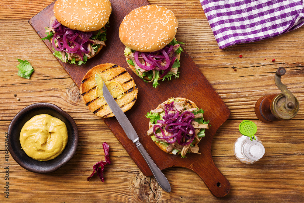 Burger with meat of duck with red onion and lettuce. Burger with meat of duck with red onion and lettuce.