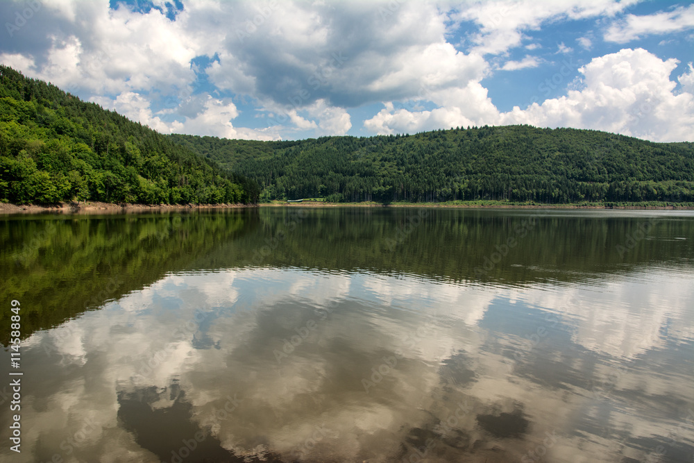 Beautiful summer day by the lake with a cloudy sky in the Carpathian mountains