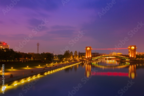 Beautiful architecture building and colorful bridge in twilight