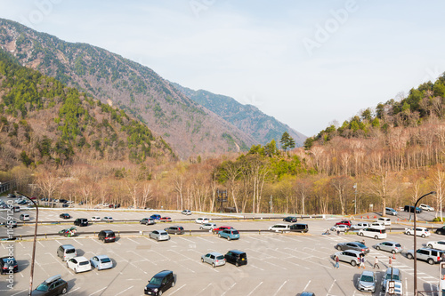 Aerial view of car parking outdoors with mountain in nature.