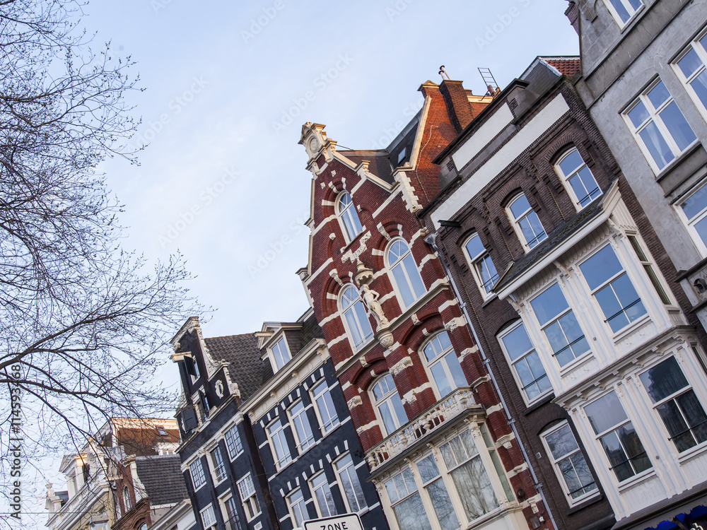 Fototapeta AMSTERDAM, NETHERLANDS on MARCH 31, 2016. Typical architectural details of houses XVII-XVIII of construction