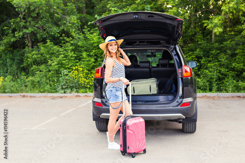 Young woman with suitcases. Vacation concept. Car trip. Summer travel. © satura_