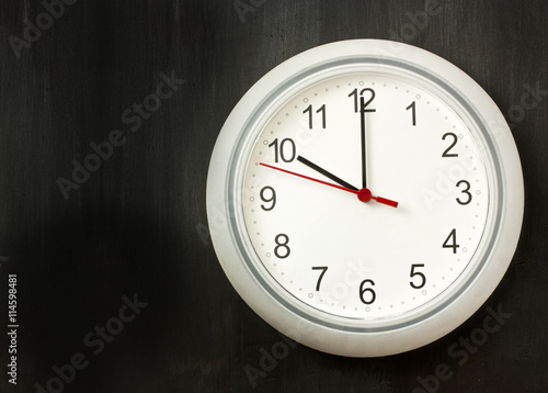 'Beginning of workday' or 'time' concept: white clock with copyspace