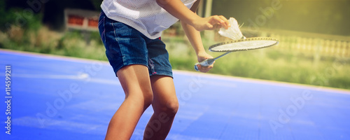 Asian children playing badmintion at the playground photo