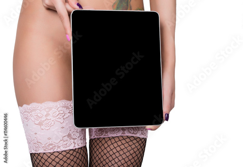 technology, internet and networking - close-up ass of girl in lacy lingerie, holding a tablet pc with a blank dark screen. Adult content
