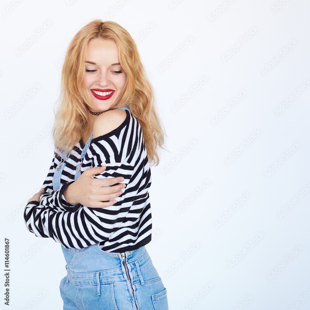 Shy young blond hair woman smiling with bare shoulder Shy young blond hair woman smiling with bare shoulder