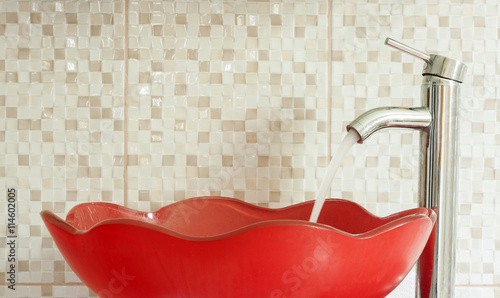 red modern sink with water tap photo