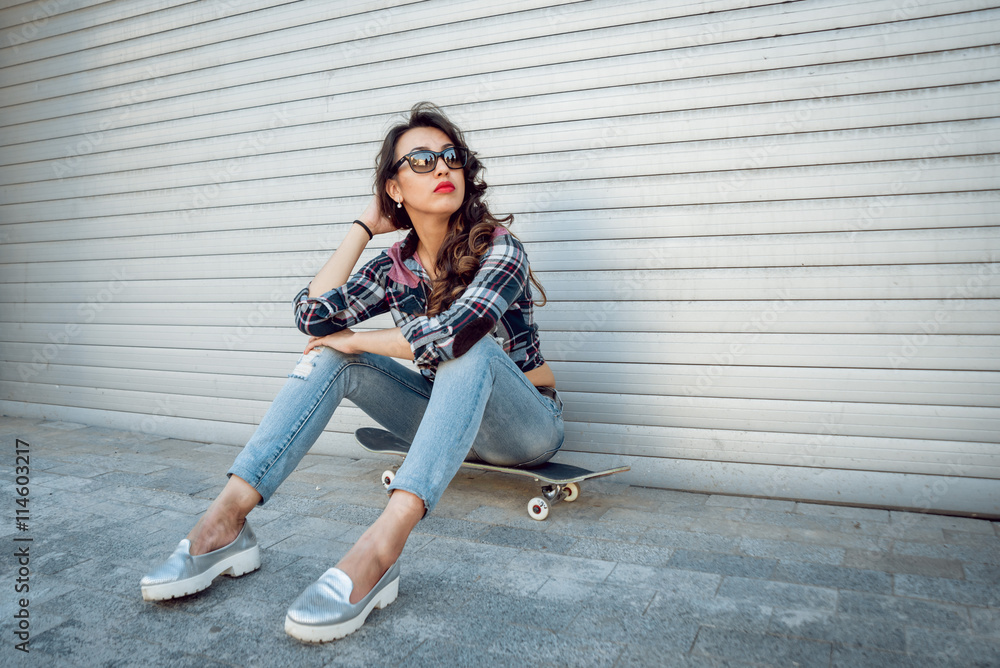 Young girl with skateboard.