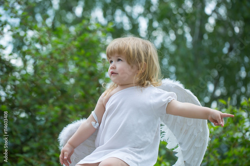 small boy in angel wings