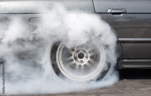 Drag racing car burning tire in preparetion for the race photo