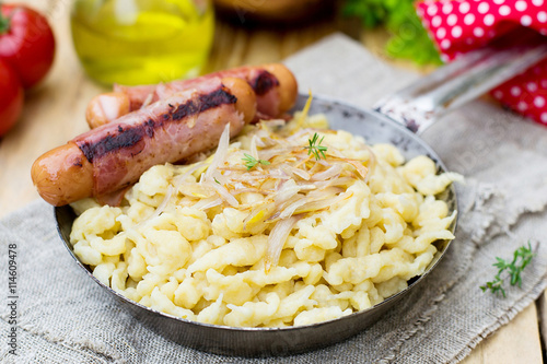 German noodles Spatzle with fried onions and sausages photo