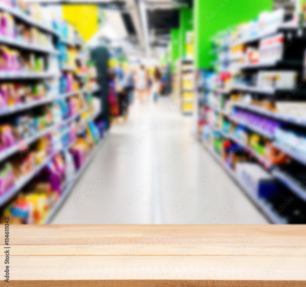 Wooden empty table in front of blurred supermarket Wooden empty table in front of blurred supermarket