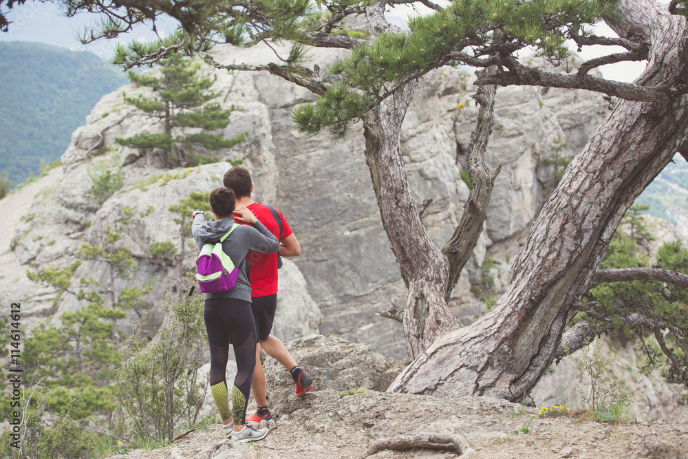 Naklejka premium Couple of hikers looking from mountain