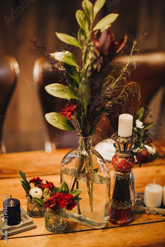 Wedding. Festive table decorated with flower arrangements, candles and greenery