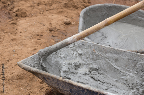 Cement blending by hoe in a tray