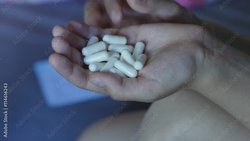 Desperate teen girl attempts to commit suicide with pills. 4K UHD. Desperate teen girl attempts to commit suicide with pills. 4K UHD.