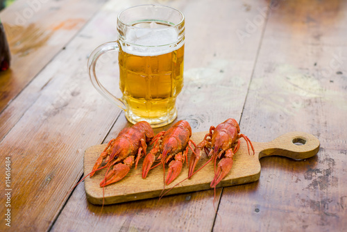 Boiled crayfish on a wooden background toning