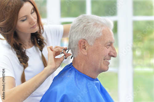 Man having a haircut from hairdresser