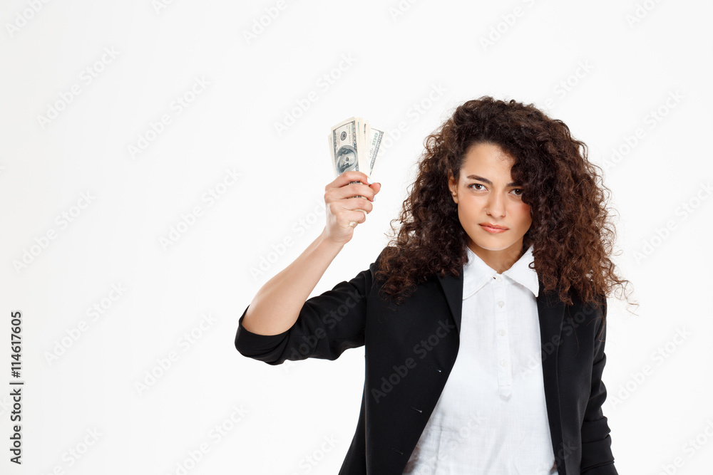 Picture of seriously curly business girl holding money Picture of seriously curly business girl holding money