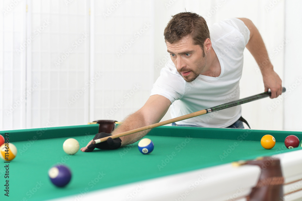 Fototapeta premium man playing billiards in billiard club